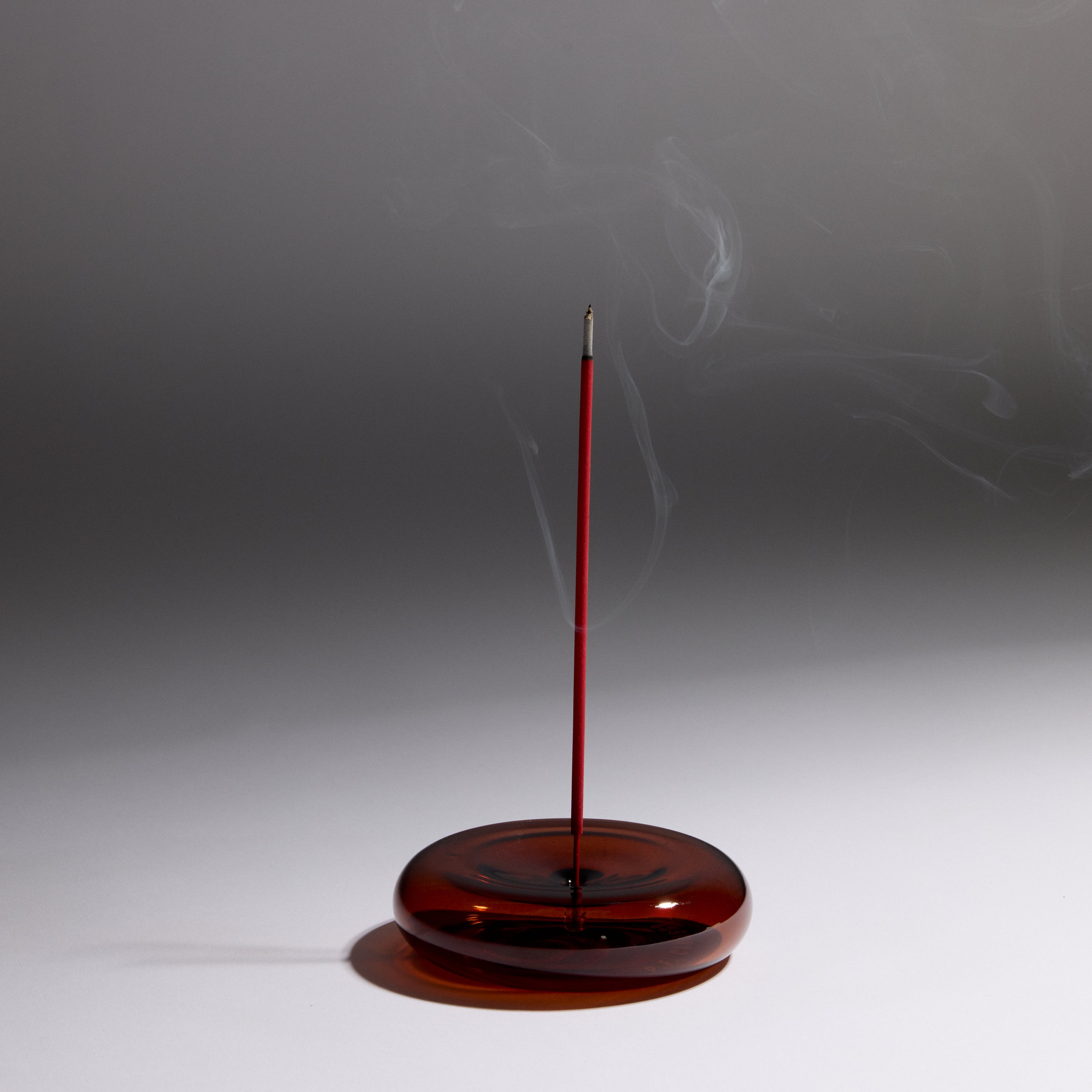 Round Glass Incense Holder with lit incense stick