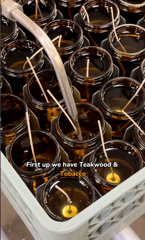 A decorative tray holding multiple candles, each topped with a stick, creating a cozy atmosphere.